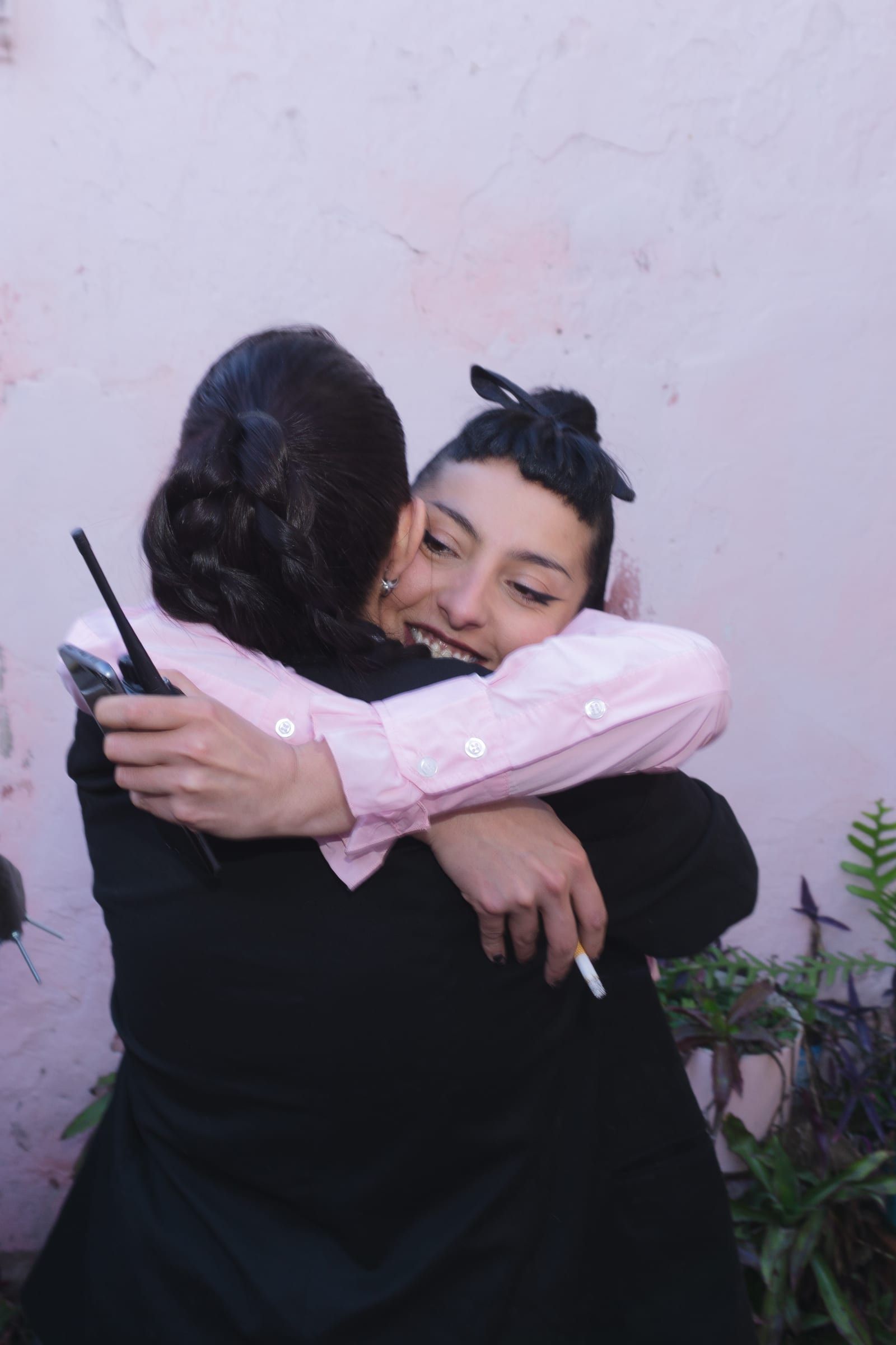 Two people hug and smile backstage.
